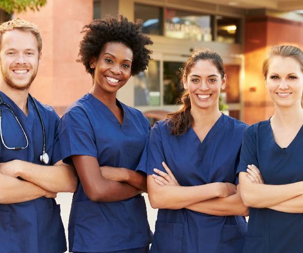 Portrait of Medical Team Standing Outside Hospital